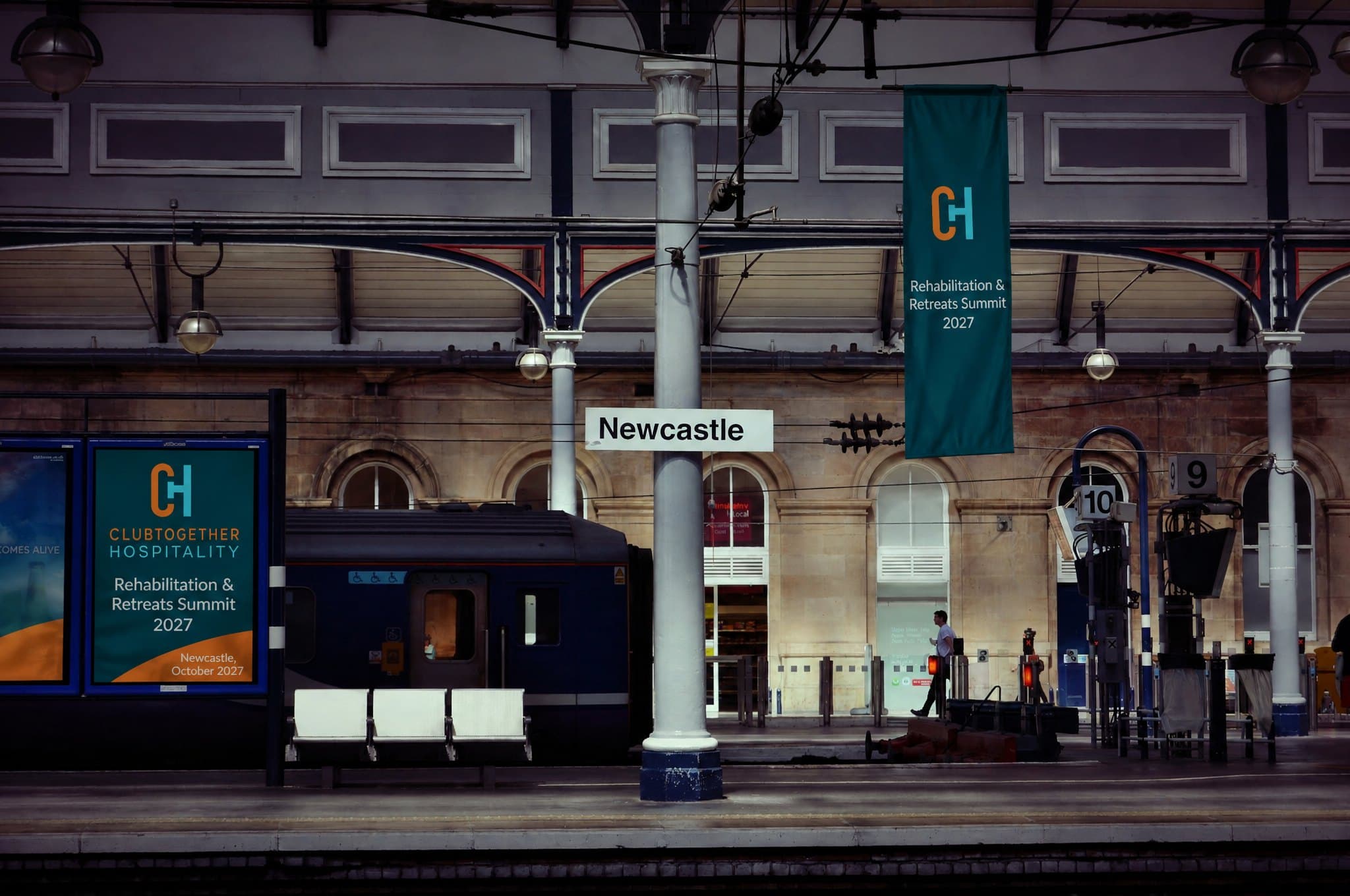 A summit poster and banner on the platform at Newcastle Central Station
