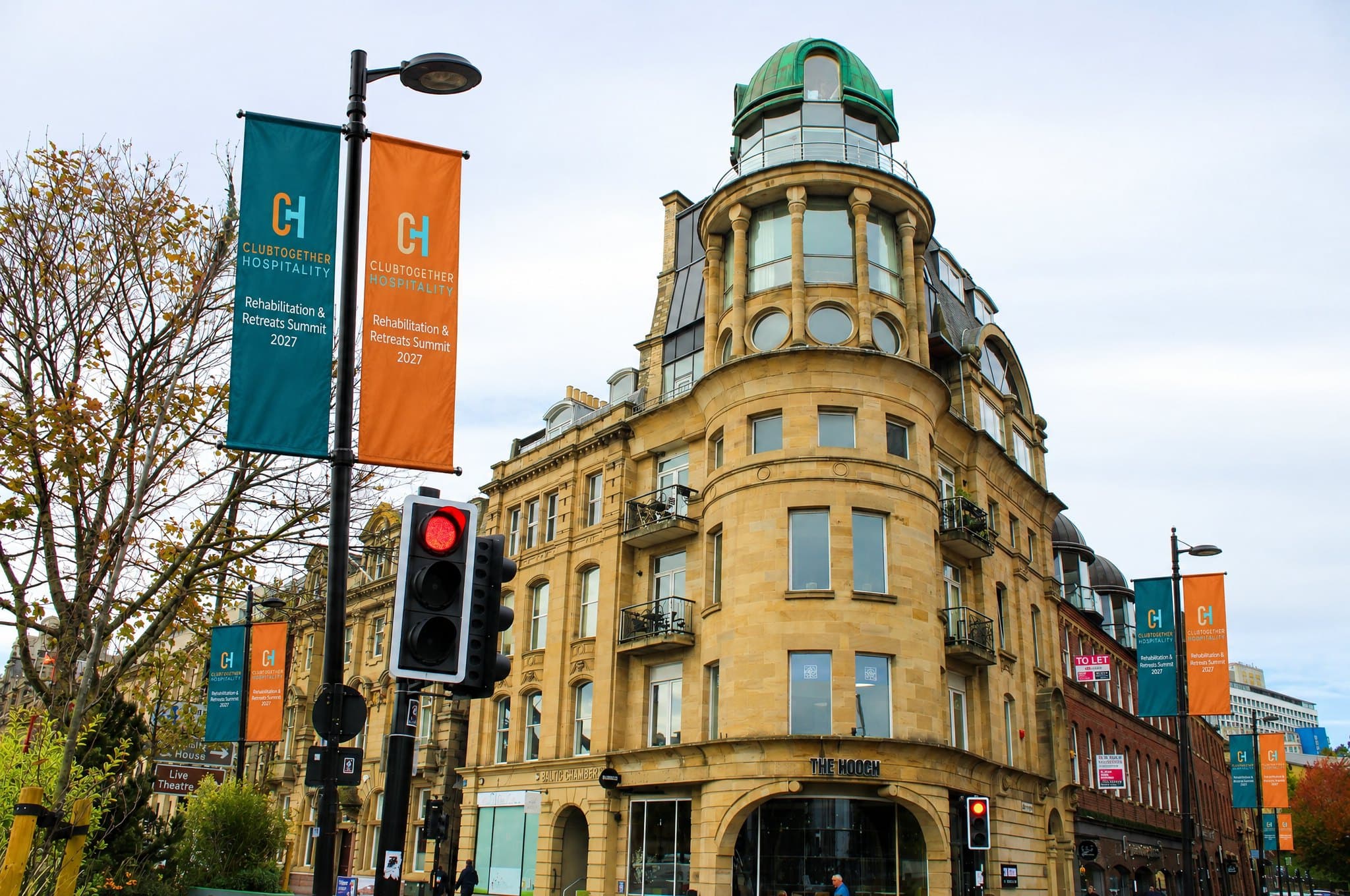 Summit banners on the lamp posts by a domed sandstone building in Newcastle city centre