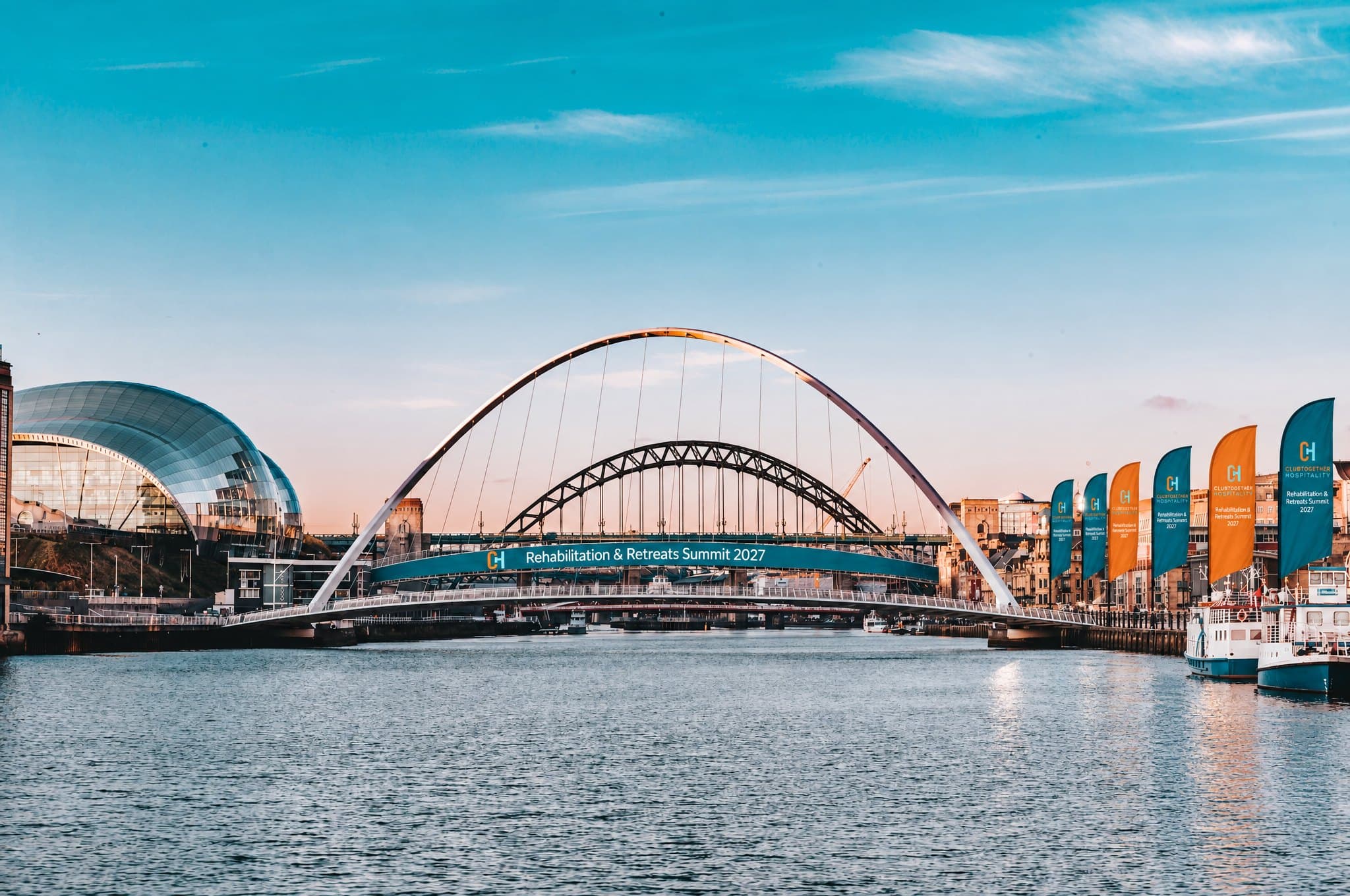 Summit flags along the quay by the Gateshead Millennium Bridge and the Sage on a clear day